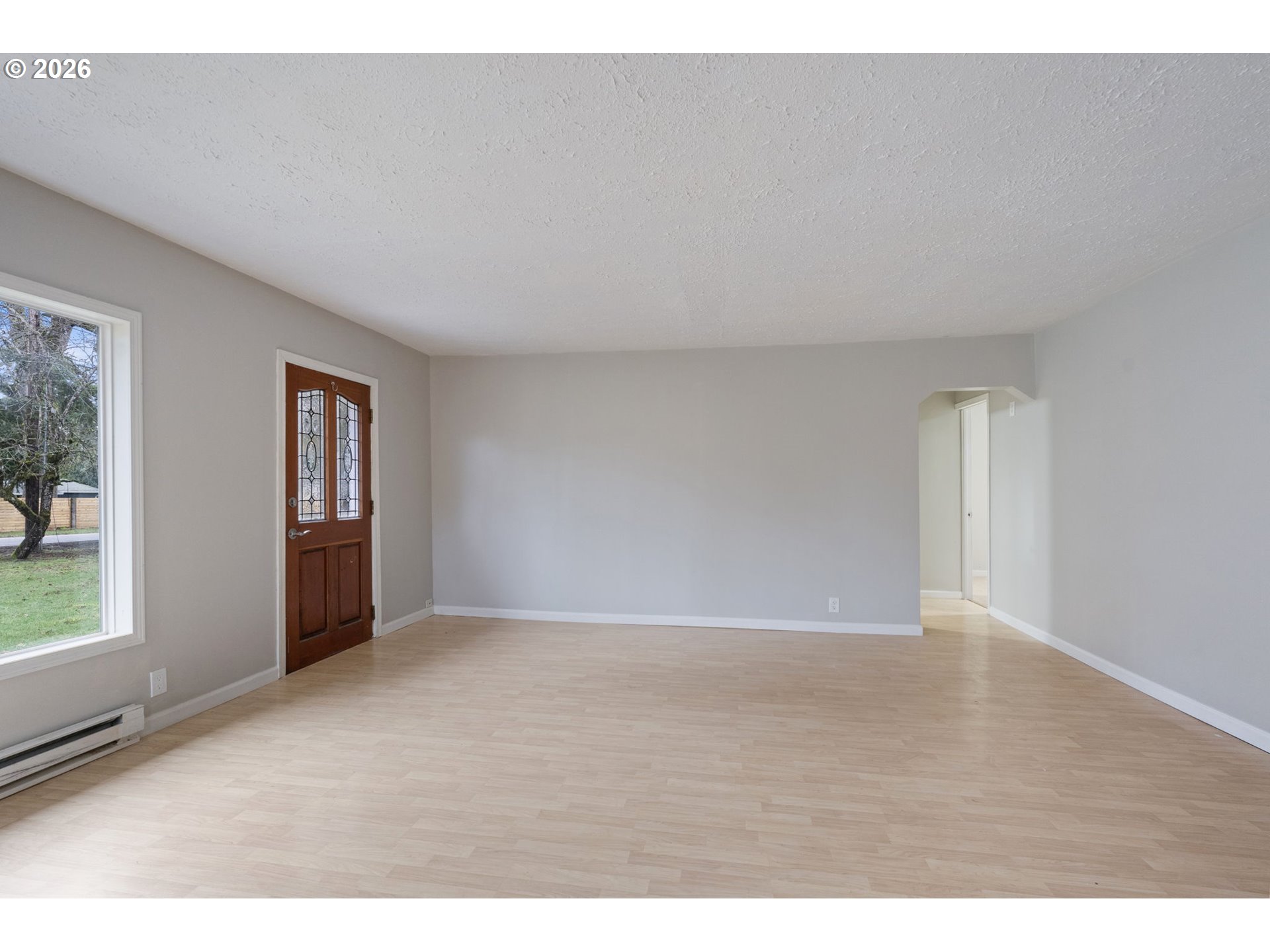 25106 Northeast 25th Street Camas, WA 98607 - Photo 6 of 47 a view of an empty room with wooden floor and a window