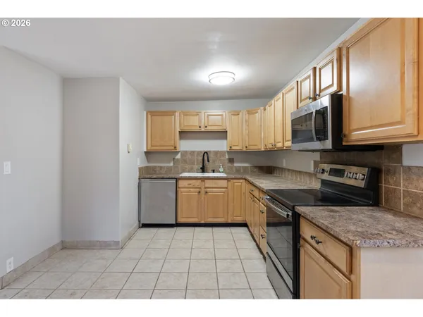 a kitchen with a stove a sink and a microwave