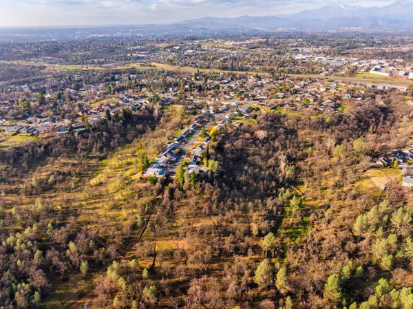an aerial view of residential houses with city view