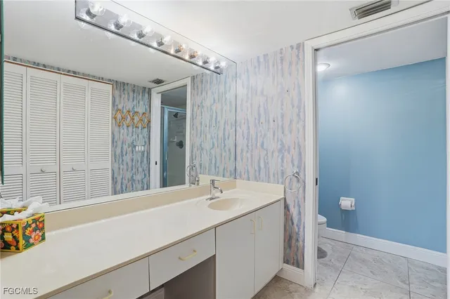 a bathroom with a sink a mirror and a shower