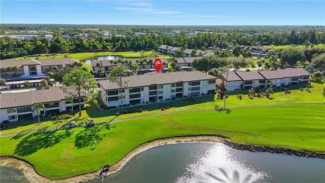 an aerial view of a house with a yard and lake view