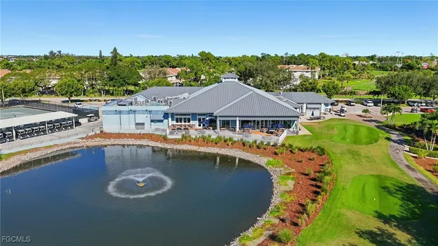 an aerial view of a house with swimming pool patio and outdoor seating