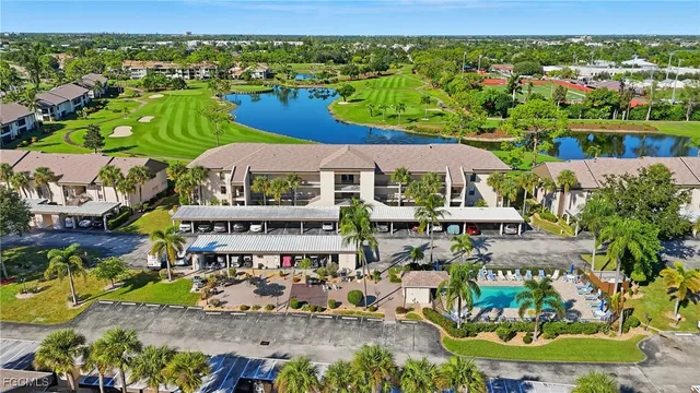 an aerial view of a house with a garden and lake view