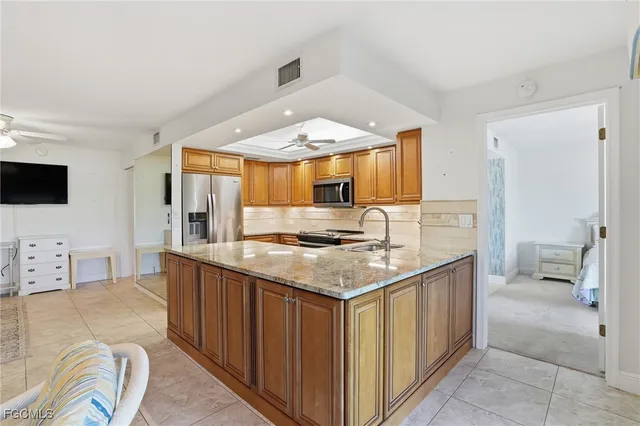 a kitchen with stainless steel appliances granite countertop a sink and cabinets