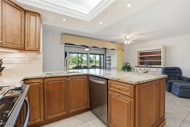 a kitchen with granite countertop a sink and a stove