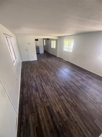 a view of a room with wooden floor and windows