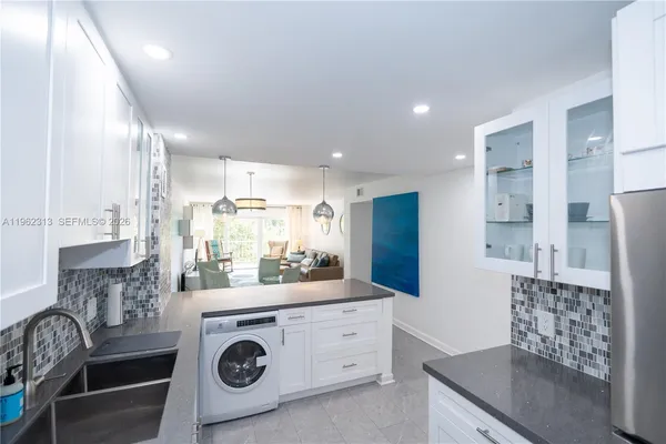 a kitchen with stainless steel appliances granite countertop a stove and a refrigerator