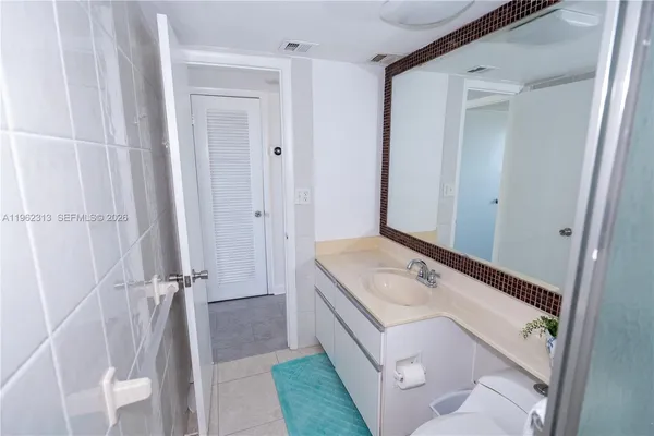a bathroom with a sink a vanity and a mirror