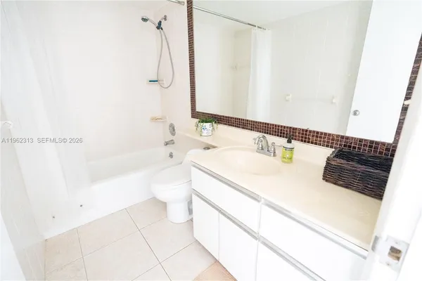 a spacious bathroom with a granite countertop sink a toilet and shower