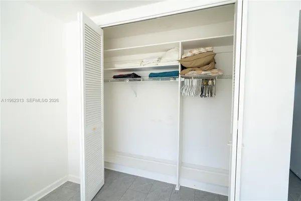 a view of a hallway with wooden floor and stairs