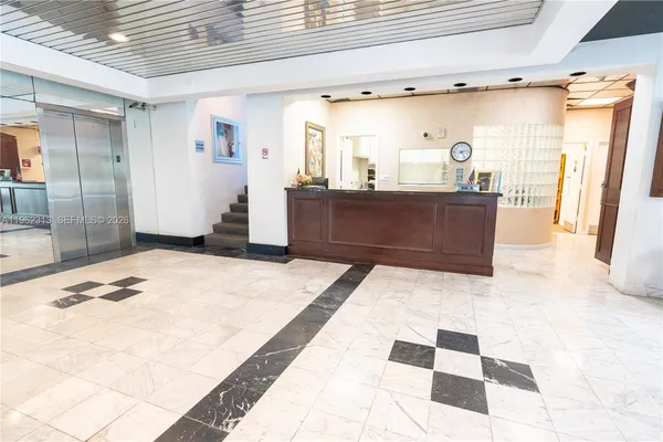 a lobby with furniture and window