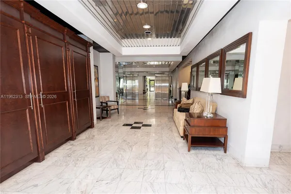 a living room with fireplace furniture and a large window
