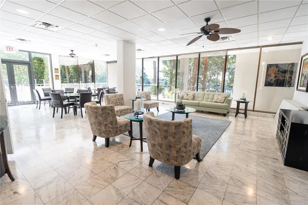 a lobby with furniture and floor to ceiling window