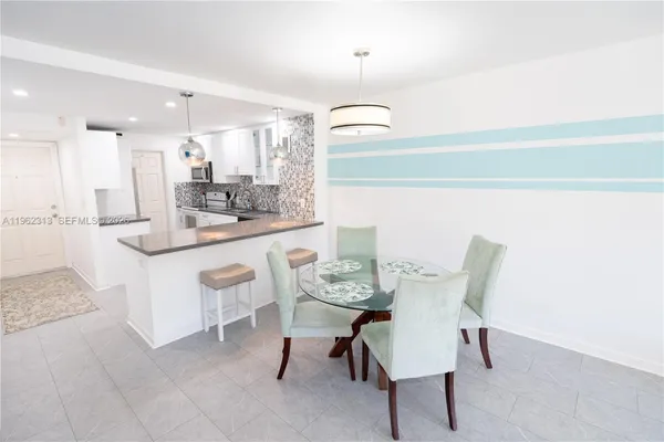 a dining room with furniture and a chandelier
