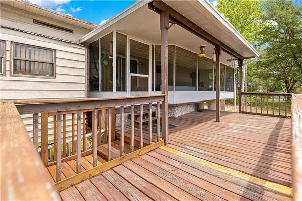 a view of a wooden deck and a yard