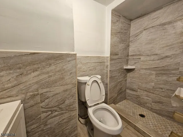 a bathroom with a toilet a sink and shower