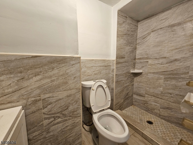 41 Ellison Street, Unit 2 Paterson, NJ 07501 - Photo 5 of 5 a bathroom with a toilet a sink and shower