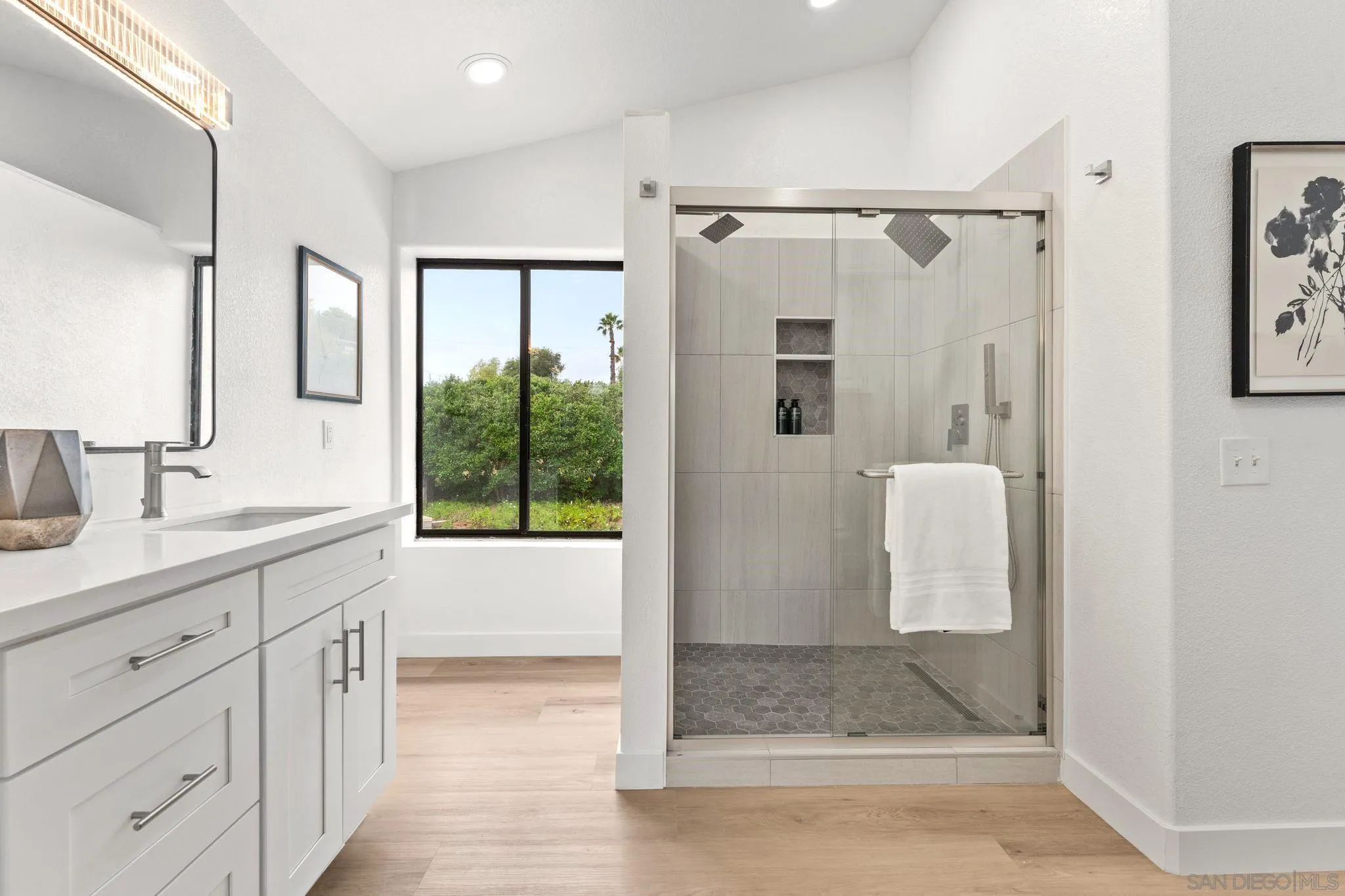 1402 Broken Arrow Lane Fallbrook, CA 92028 - Photo 23 of 34 a bathroom with a granite countertop sink a mirror and shower