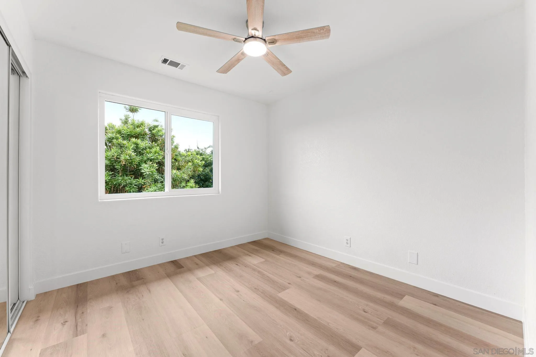 1402 Broken Arrow Lane Fallbrook, CA 92028 - Photo 26 of 34 an empty room with a window and a ceiling fan