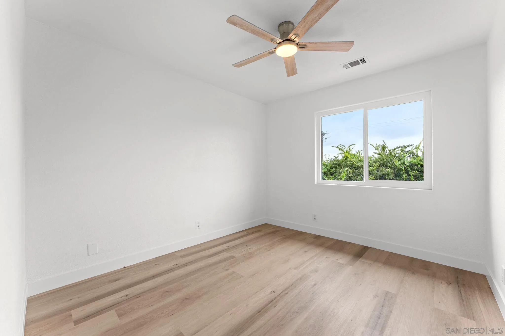 1402 Broken Arrow Lane Fallbrook, CA 92028 - Photo 27 of 34 an empty room with a window and a fan