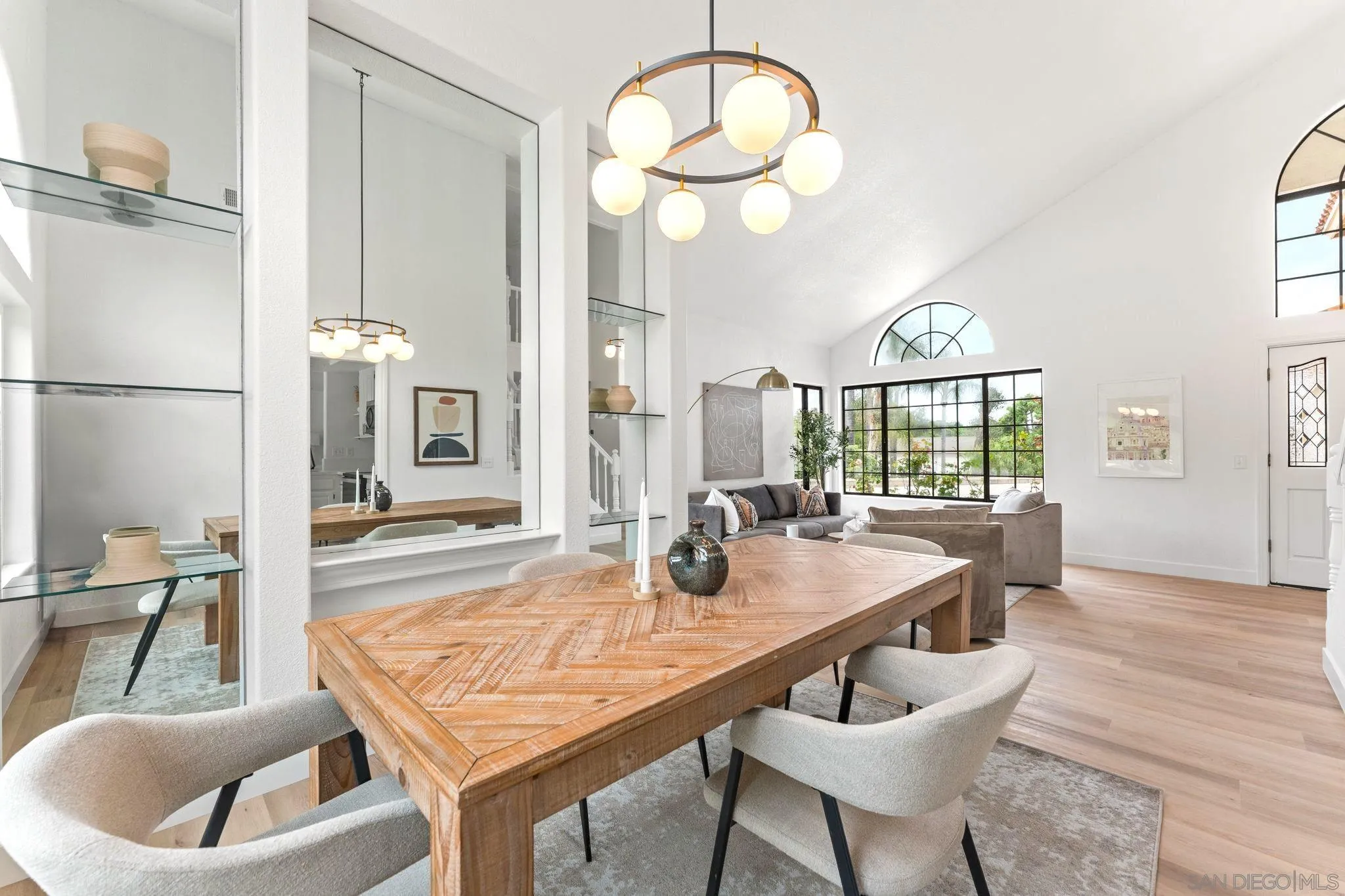 1402 Broken Arrow Lane Fallbrook, CA 92028 - Photo 5 of 34 a dining room with wooden floor a chandelier a wooden table and chairs