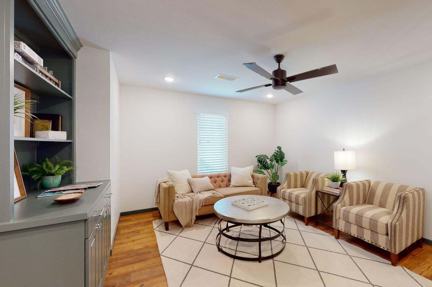 3617 128th Street Lubbock, TX 79423 - Photo 16 of 30 a living room with furniture and a chandelier