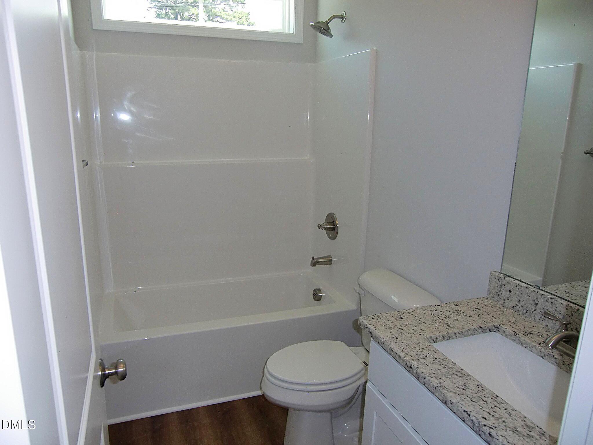 100 Covington Lane Dunn, NC 28334 - Photo 53 of 61 a bathroom with a granite countertop toilet a sink and bathtub