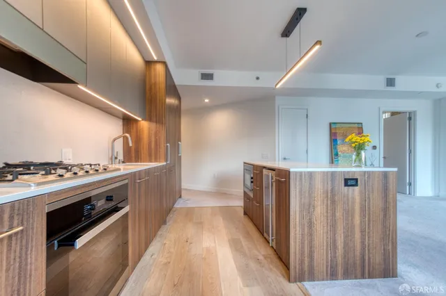 a view of a kitchen with wooden floor