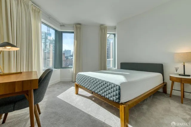 a bedroom with a bed chair and a window