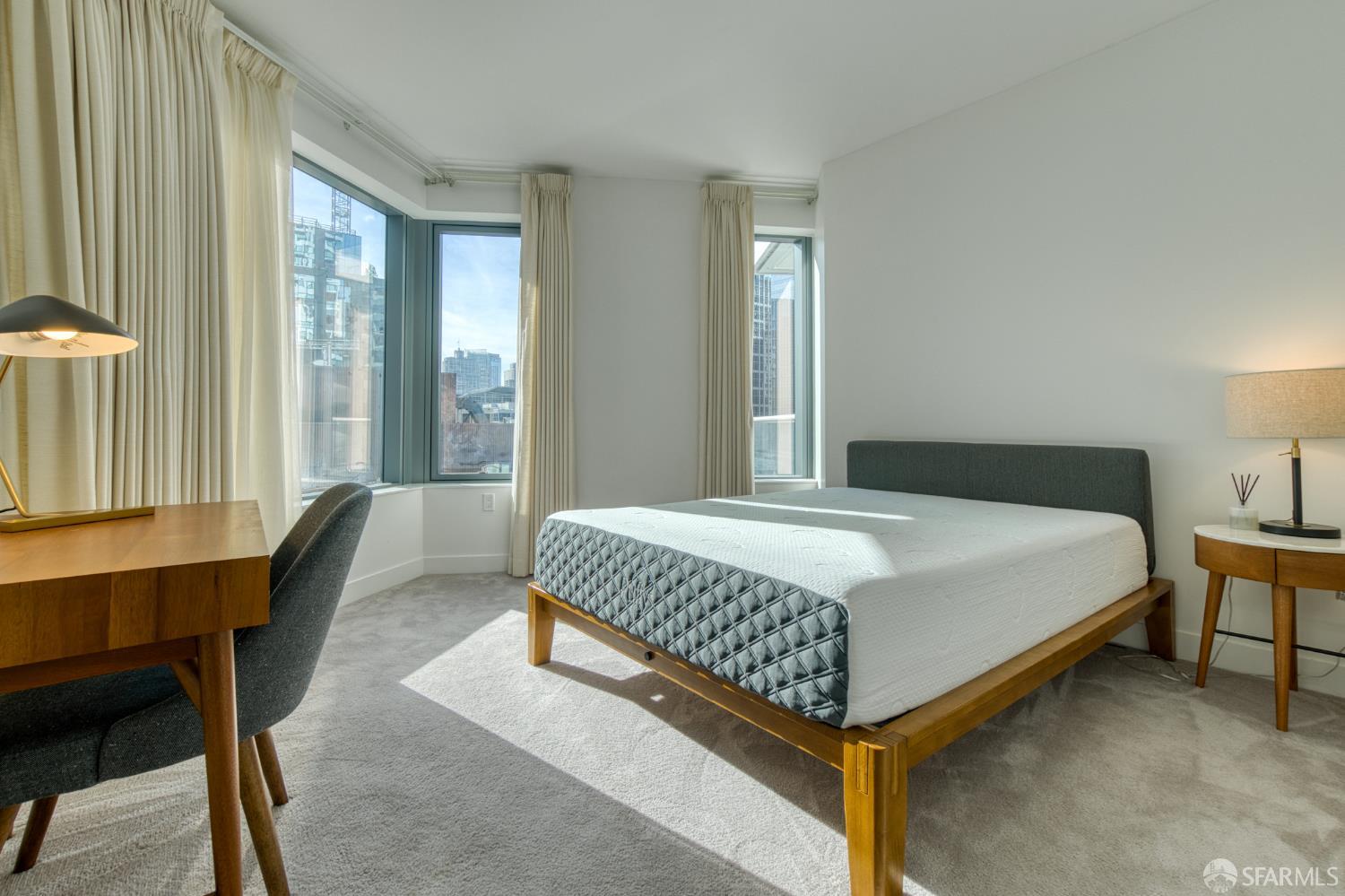 280 Spear Street, Unit 9C San Francisco, CA 94105 - Photo 7 of 11 a bedroom with a bed chair and a window