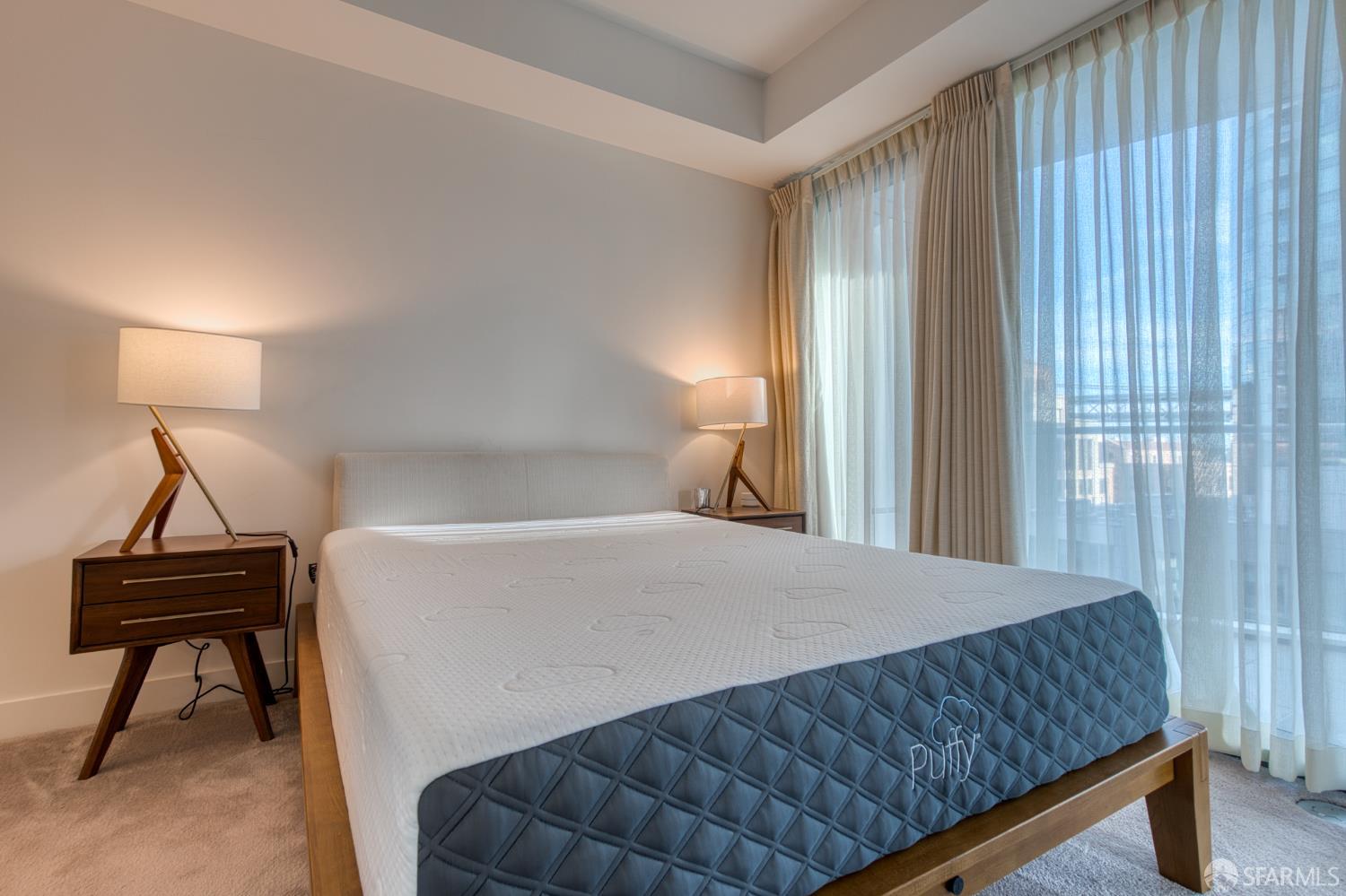 280 Spear Street, Unit 9C San Francisco, CA 94105 - Photo 9 of 11 a bedroom with a bed and a window