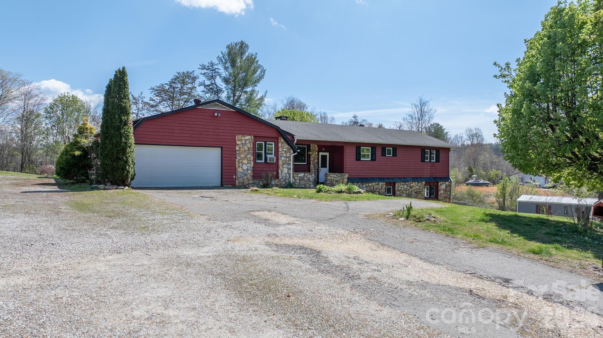 103 Bernice Street Marion, NC 28752 - Photo 2 of 48 a front view of a house with a yard and garage