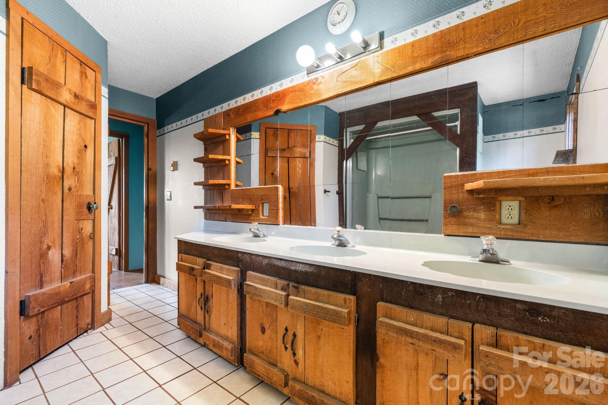 103 Bernice Street Marion, NC 28752 - Photo 21 of 48 a bathroom with a double vanity sink and a mirror