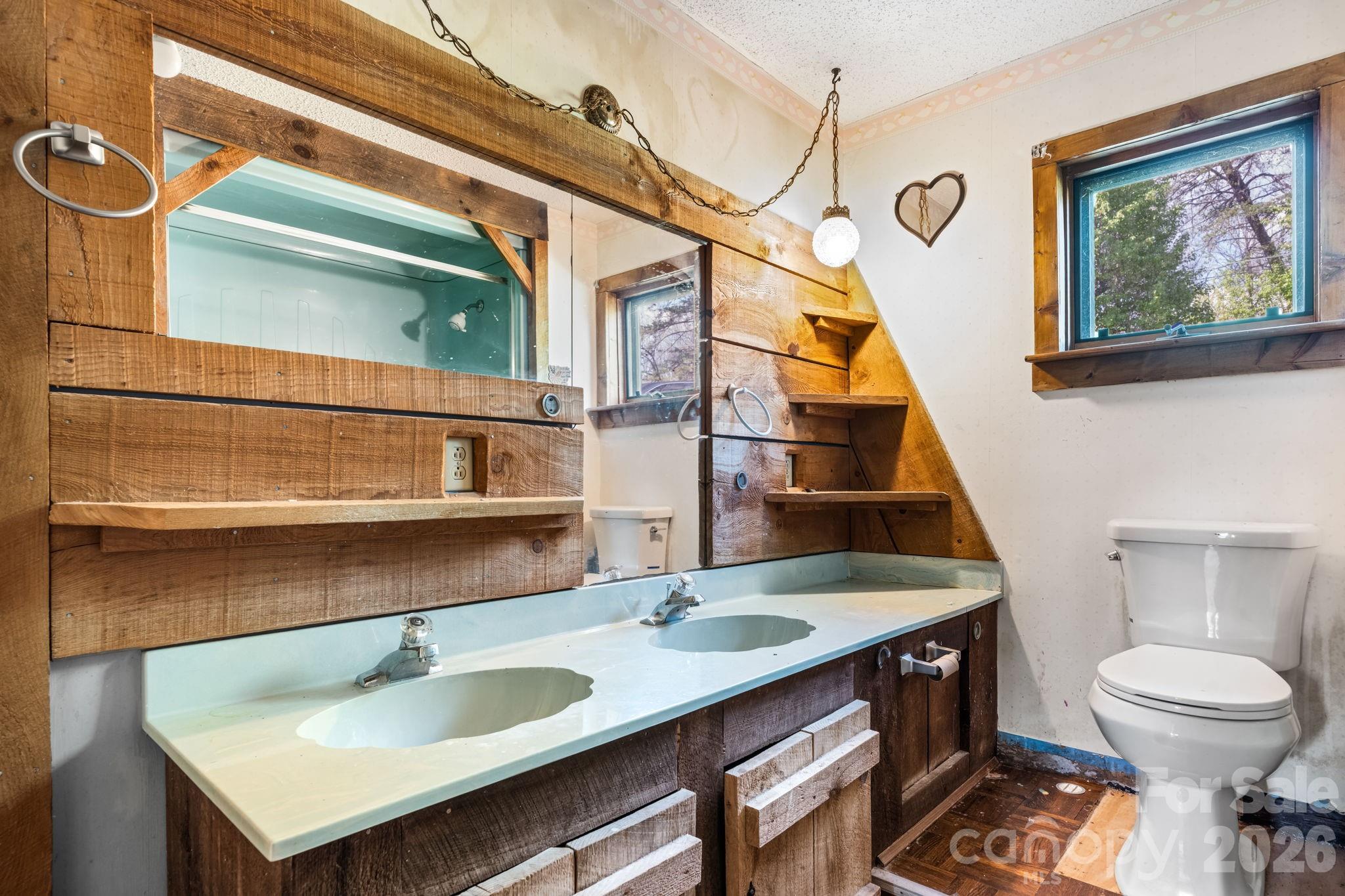 103 Bernice Street Marion, NC 28752 - Photo 23 of 48 a bathroom with a sink a toilet and a mirror
