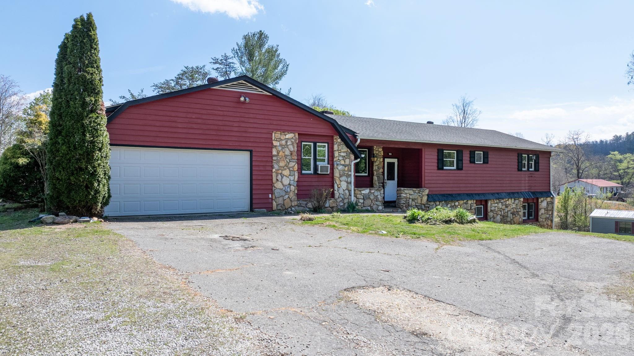 103 Bernice Street Marion, NC 28752 - Photo 3 of 48 a front view of a house with a yard and garage