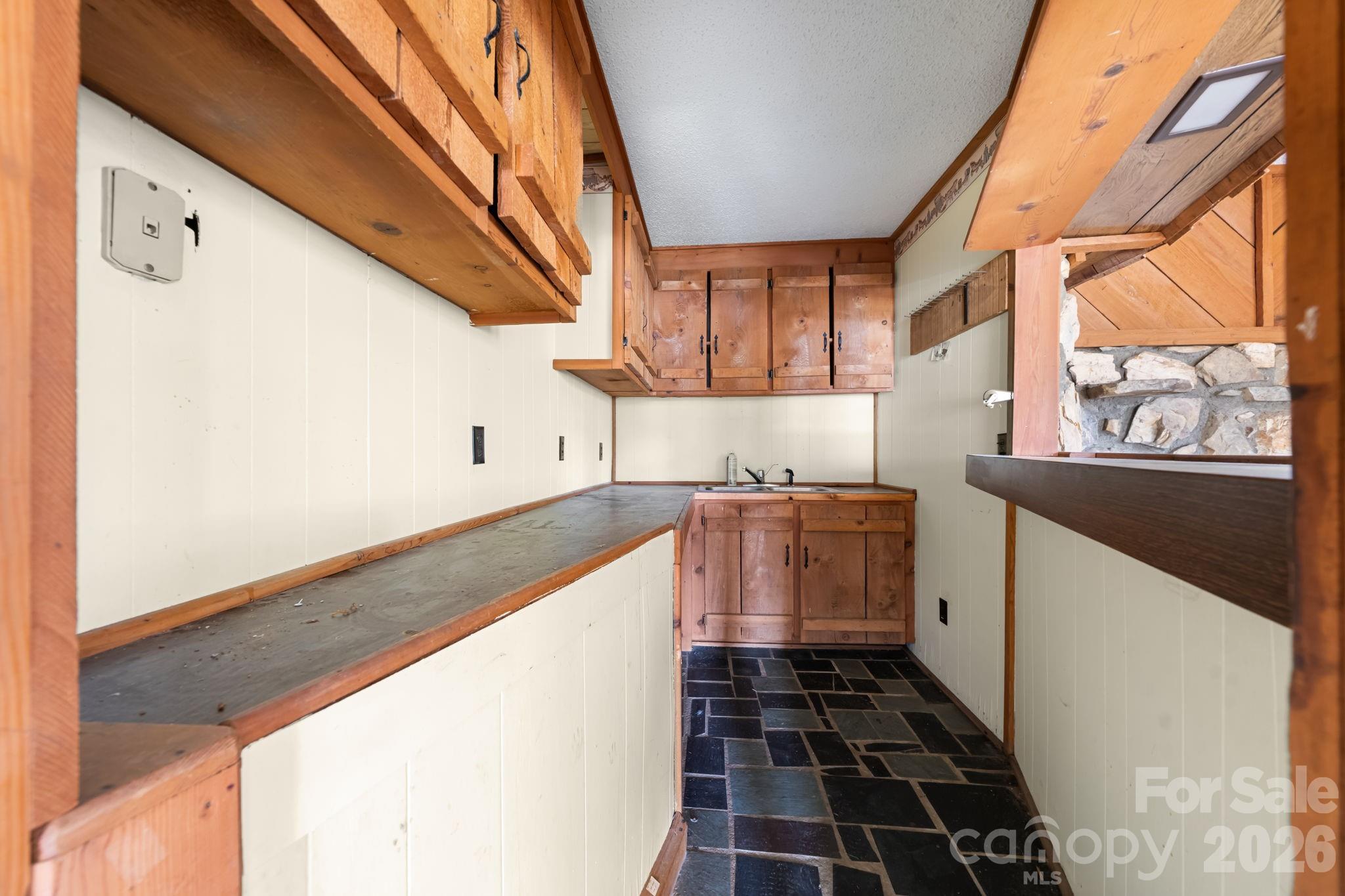 103 Bernice Street Marion, NC 28752 - Photo 32 of 48 a kitchen with granite countertop a stove and a sink