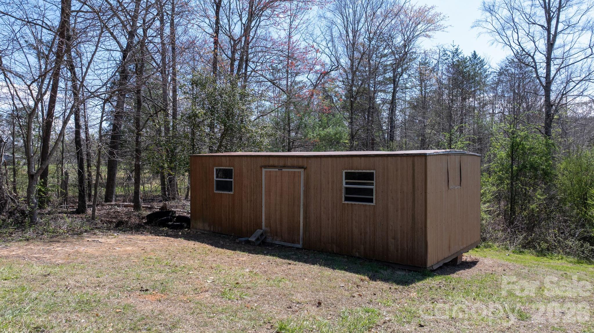 103 Bernice Street Marion, NC 28752 - Photo 40 of 48 a view of backyard of house with trees and wooden fence