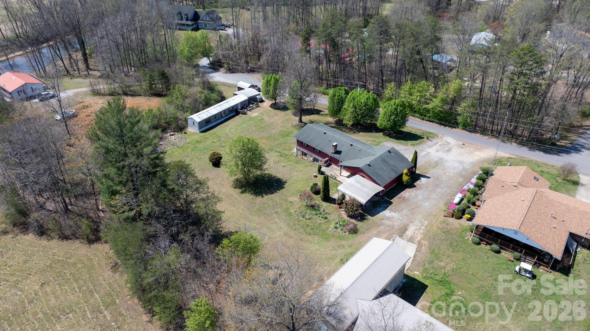 103 Bernice Street Marion, NC 28752 - Photo 47 of 48 an aerial view of a house with a yard and lake