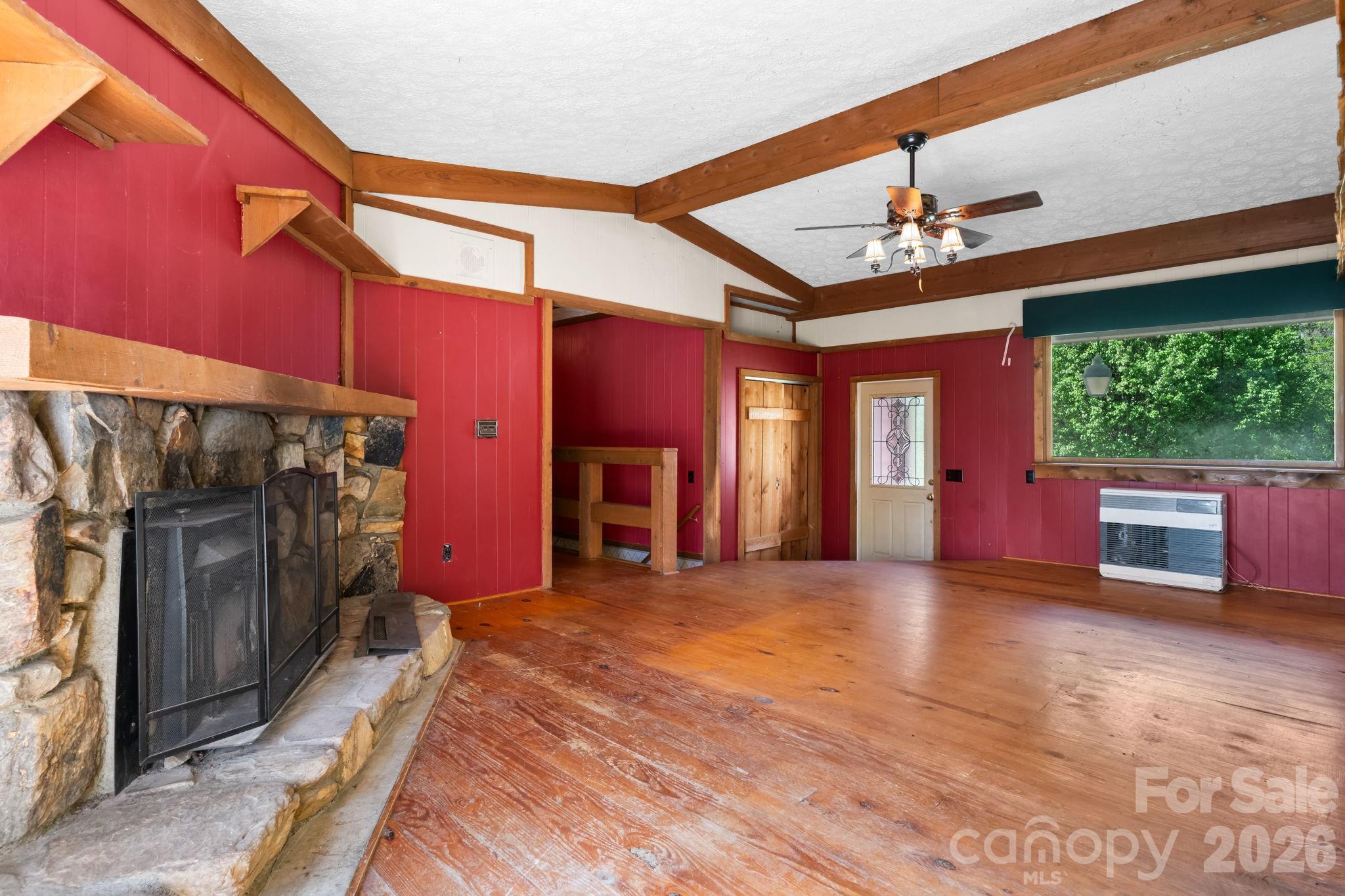 103 Bernice Street Marion, NC 28752 - Photo 8 of 48 a view of an empty room with a fireplace and a window