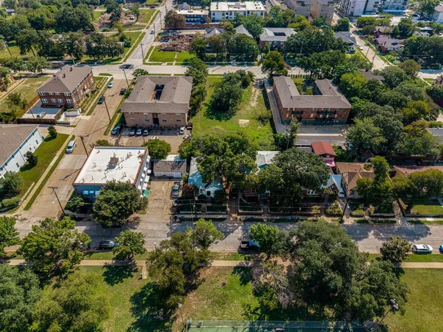 an aerial view of residential houses with outdoor space