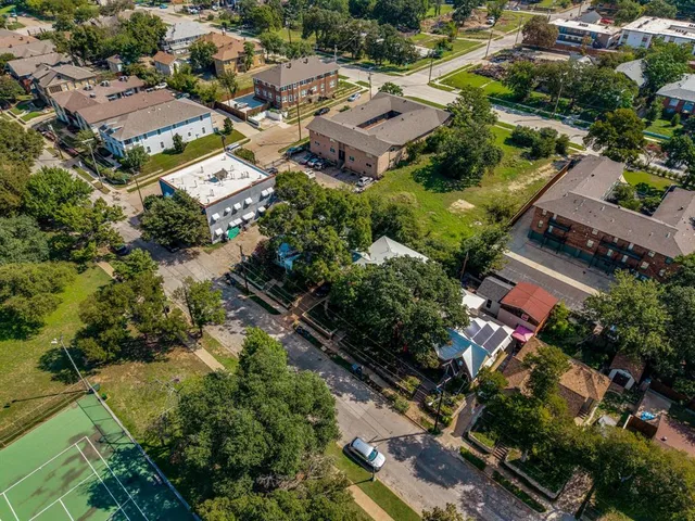 an aerial view of residential houses with outdoor space