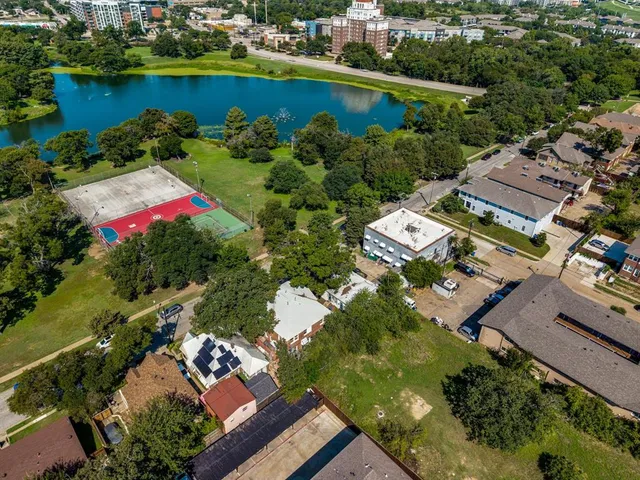 an aerial view of a house with a garden and lake view