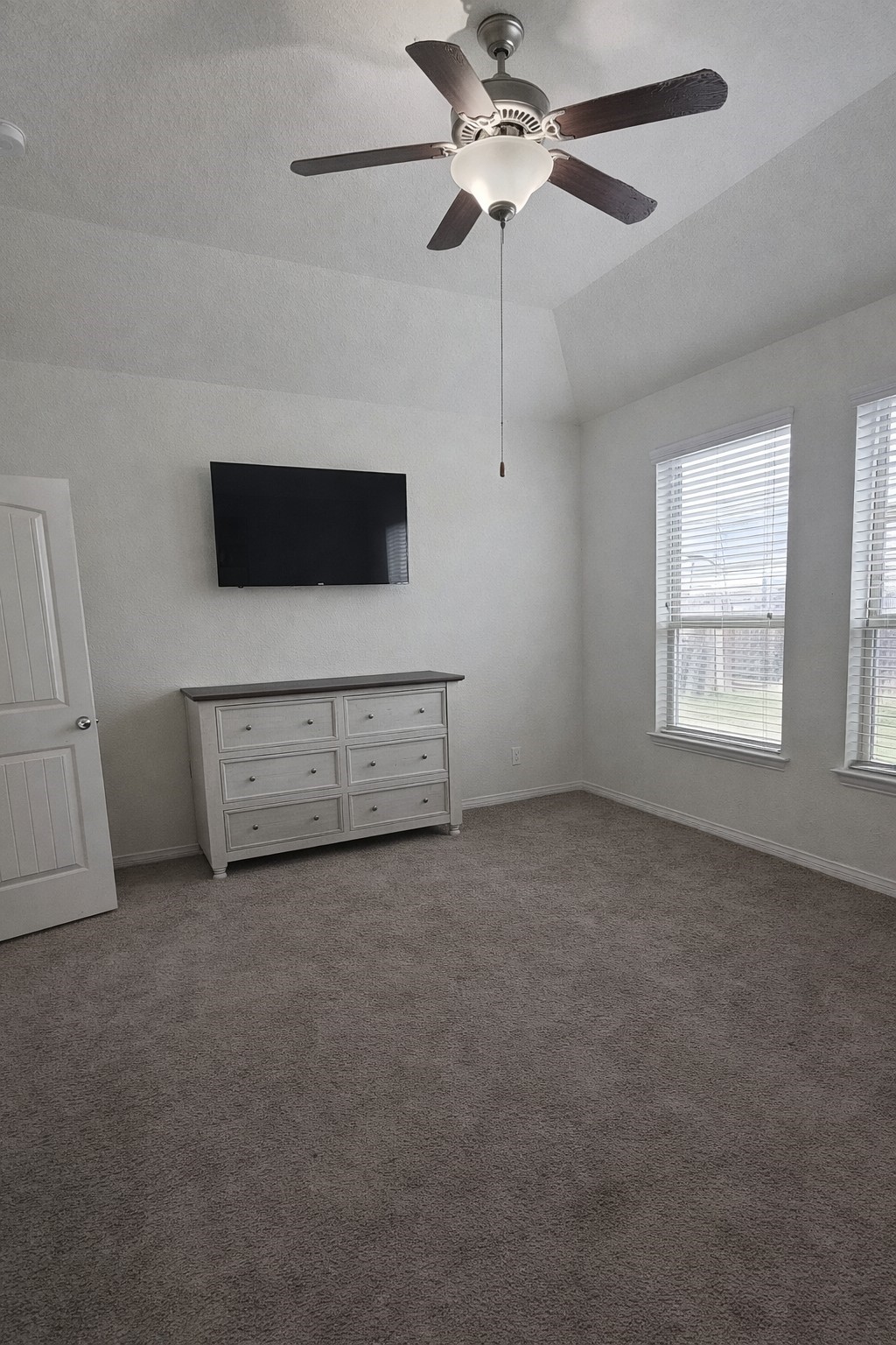 16410 Regal Exeter Drive Houston, TX 77073 - Photo 13 of 21 en empty room with windows and fan