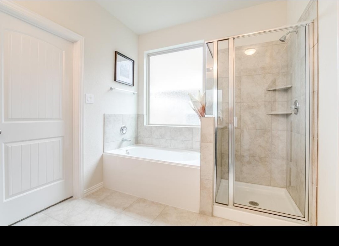 16410 Regal Exeter Drive Houston, TX 77073 - Photo 14 of 21 a bathroom with a bathtub and a shower