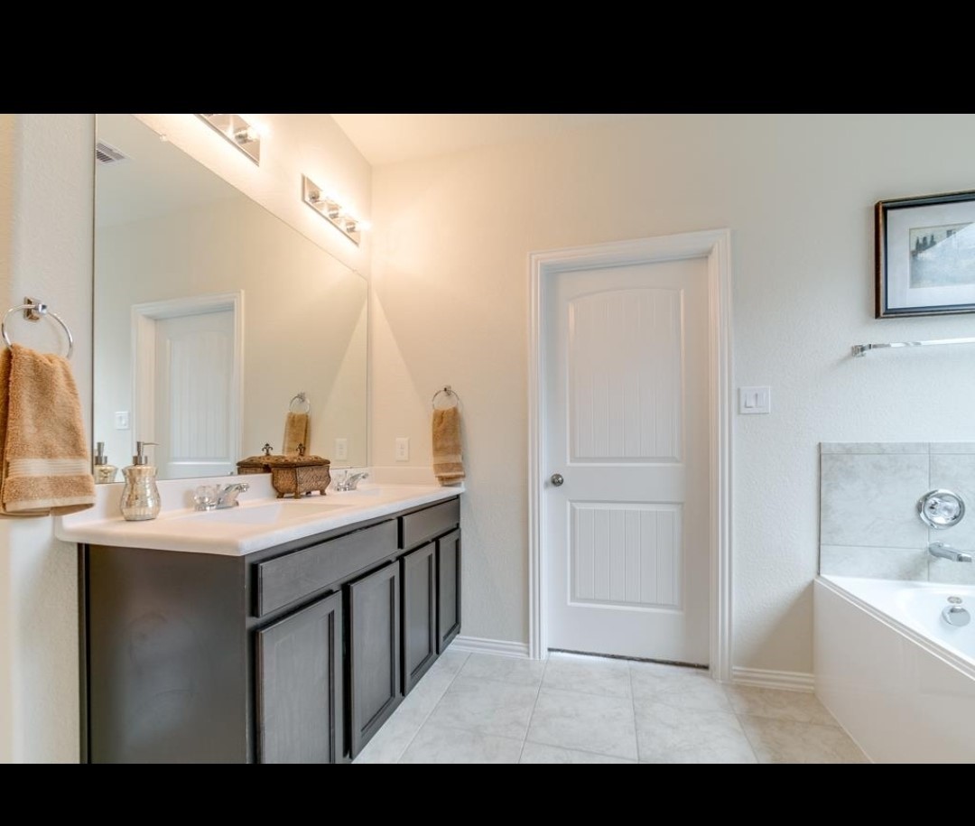 16410 Regal Exeter Drive Houston, TX 77073 - Photo 15 of 21 a bathroom with a sink a mirror and a bathtub