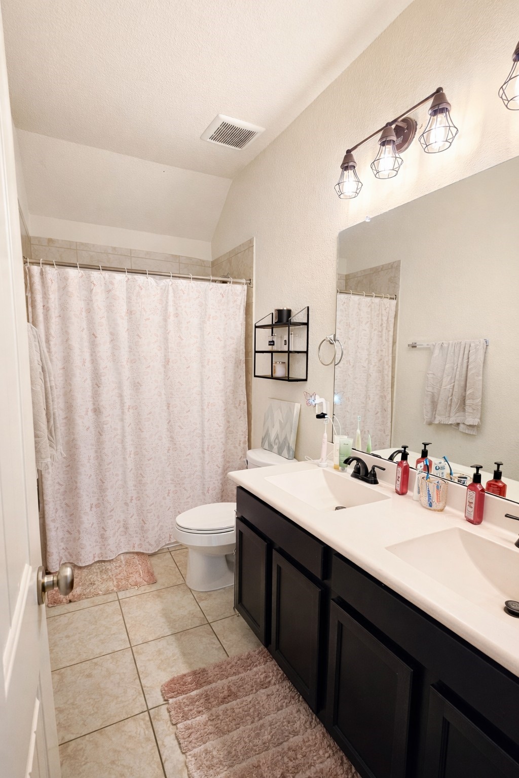 16410 Regal Exeter Drive Houston, TX 77073 - Photo 18 of 21 a bathroom with a double vanity sink and a mirror