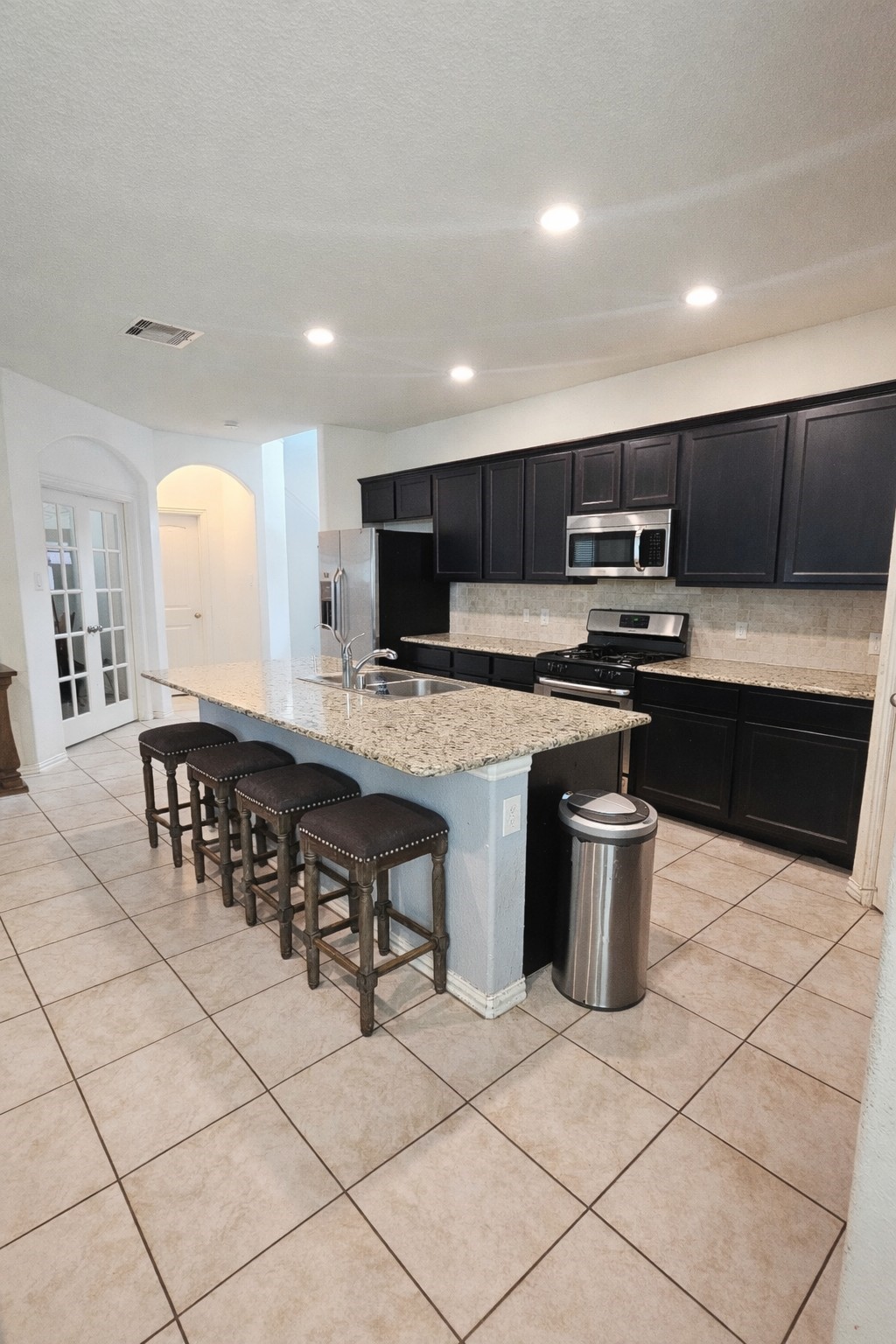 16410 Regal Exeter Drive Houston, TX 77073 - Photo 5 of 21 a large kitchen with stainless steel appliances a sink a stove a microwave a counter top space and cabinets