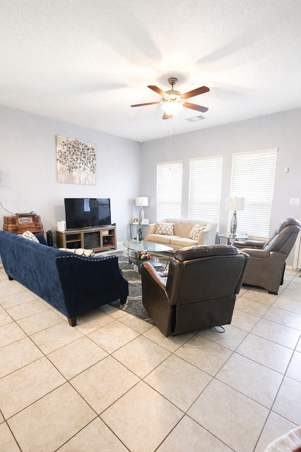 16410 Regal Exeter Drive Houston, TX 77073 - Photo 9 of 21 a living room with furniture and a flat screen tv