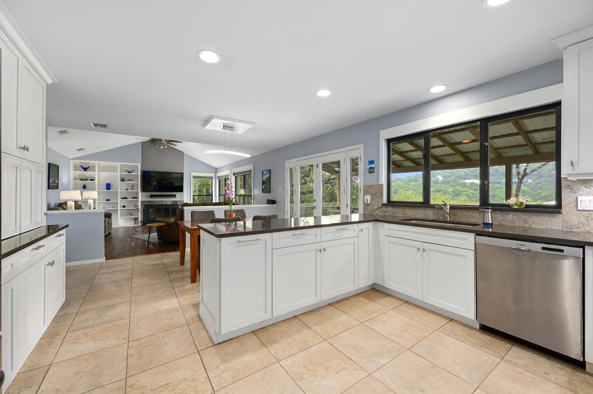 2009 South Oak Canyon Road Austin, TX 78746 - Photo 15 of 37 a kitchen with stainless steel appliances granite countertop a stove and more cabinets