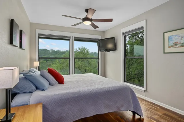 a bed sitting in a bedroom next to a window